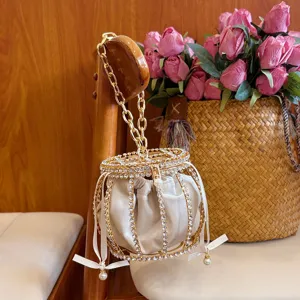 Rhinestone cage bucket evening bag with gold chain handle and white velvet inner pouch for party use.