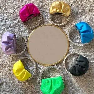 Detailed view of colorful pleated evening clutch bags with stunning crystal rhinestone handle loops.