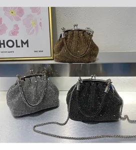 Detailed view of sparkly rhinestone mini shell clutch bags with metal frames and chic chain straps.