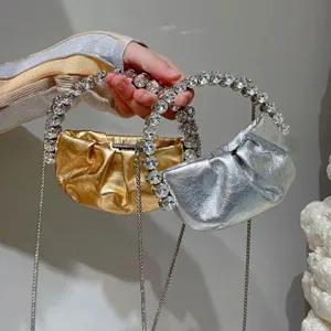 Detailed view of the luxury crystal handle pleated mini evening clutch bag with chain strap.