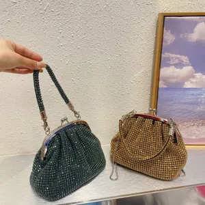 Sparkling evening shell clutch detail showcasing exquisite handmade rhinestones and metal clasp.
