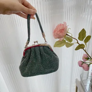 Shiny green rhinestone evening clutch bag with metal kiss lock and beaded handle for women.