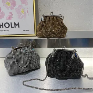 Sparkling rhinestone evening clutch bag with metal frame kiss-lock closure and chain strap.