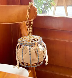 Rhinestone metal cage bucket bag with chain handle and inner pouch for evening party.