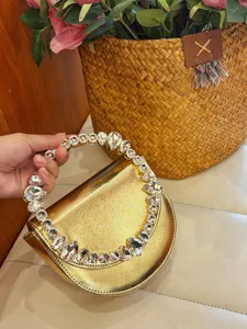 Elegant metallic gold evening handbag with stunning rhinestone crystal handle for party and wedding.