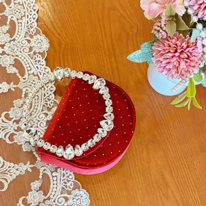 Red velvet evening bag with sparkling rhinestone handle and elegant crystal dots for women.