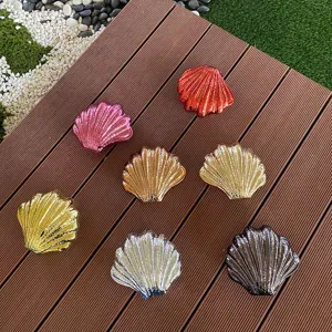 Detailed shot showcasing glossy shell-shaped acrylic evening bags in various vibrant colors.