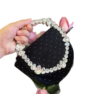 Black velvet evening bag with crystal rhinestone handle and polka dot studs for women elegant party.