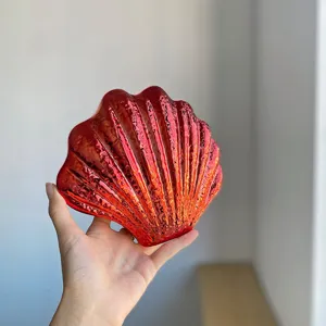 Close-up detail of the glossy red acrylic shell clutch bag, showing metallic shiny surface.