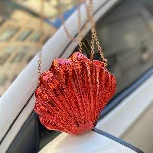 Shell acrylic evening bag detail view, glossy metallic red crossbody purse for women.