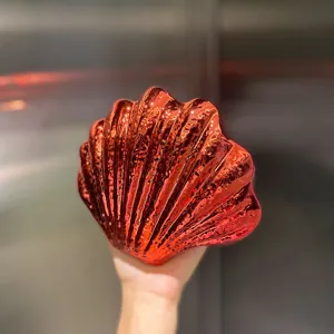 Red shell acrylic evening bag clutch, glossy metallic finish and textured surface detail.
