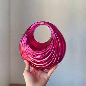 Metallic pink ribbed acrylic handbag, unique vintage round design, elegant style detail.