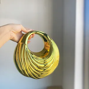 Close-up view of the stylish gold pleated acrylic handbag featuring unique sculptural texture design.