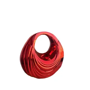 Glossy red abstract acrylic handbag, unique wavy textured vintage circular handle chic bag.