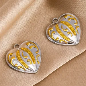 Close up of silver and gold stainless steel heart pendant detail for DIY jewelry making accessories.