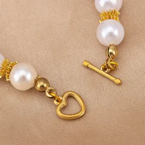 Close-up of DIY jewelry OT clasp heart shaped metal toggle closure with pearls for bracelets.