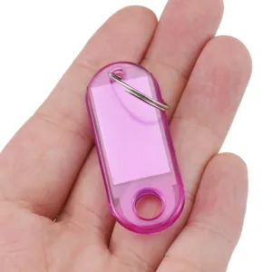 Transparent plastic key tags with split rings, colored hotel number sorting luggage labels.