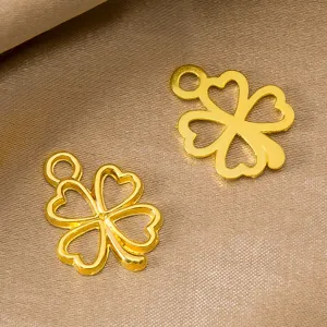 Detail shot of golden hollow four-leaf clover alloy pendant, perfect for DIY jewelry making.