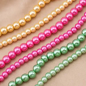 Close-up details of vibrant colorful glass imitation pearl bead strands for DIY jewelry making.