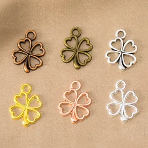 Close-up detail of hollow four-leaf clover alloy charms, multi-color DIY jewelry findings.