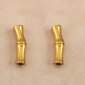 Close-up of golden curved bamboo tube spacer beads, premium stainless steel DIY jewelry finding.