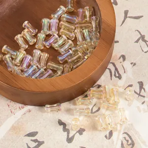 Vue détaillée de perles de verre translucides irisées pour fabrication de bijoux et bracelets.