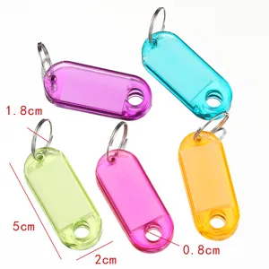 Colorful transparent plastic key tags with metal split rings for hotel room and luggage use.