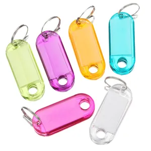 Colorful transparent plastic key tags with rings and label inserts for hotel luggage sorting.