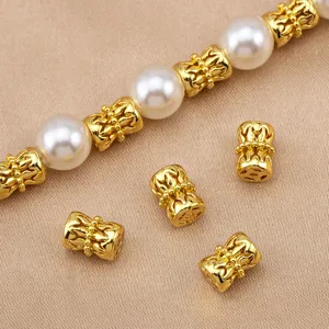 Gold hollow flower drum spacer beads mixed with white pearls, perfect for DIY jewelry making.