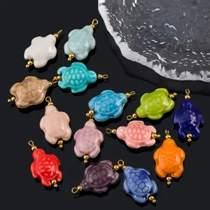 Detailed shot of colorful ceramic turtle pendants with gold loops for DIY jewelry making accessories.