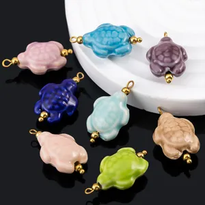 Detailed view of colorful ceramic turtle pendants with gold-plated loops for DIY jewelry.