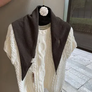 Dark brown knitted triangular scarf for women, cozy autumn winter retro fashion accessory.