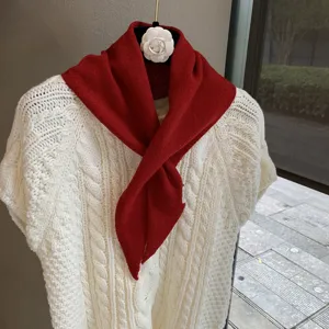 Red knitted triangular scarf for women, soft cozy winter neck warmer and stylish mini shawl.