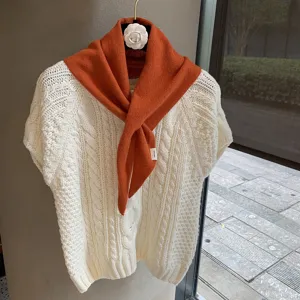 Knit white sweater and orange scarf detail view, soft wool texture, cozy autumn chic style.