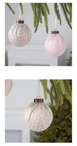 Close-up of tweed fabric Christmas tree ball ornaments featuring rustic metal caps and white ribbons.