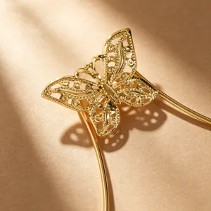 Gold butterfly body chain detail shot, stylish metallic chest harness for party bikini wear.