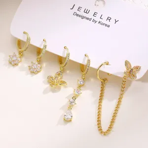 Gold-plated rhinestone flower butterfly chain ear cuff set detail view, piercing jewelry style