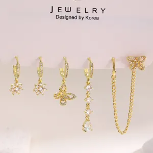 Exquisite gold rhinestone earring set, multi-piece butterfly chain piercing jewelry detail.