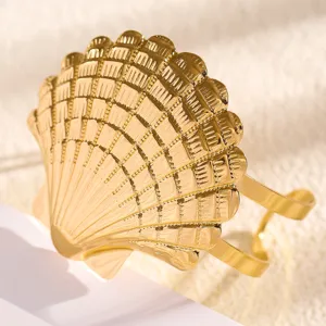 Gold seashell arm cuff detail shot, beach vacation open armband fashion jewelry for women