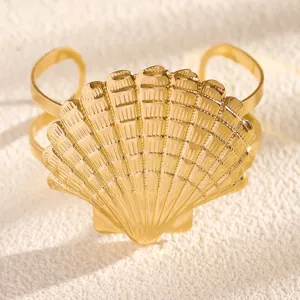 Gold seashell cuff bracelet, beach vacation style open armlet detail view for women.