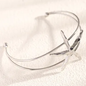 Detailed view of silver starfish open arm cuff bracelet, perfect for beach style.