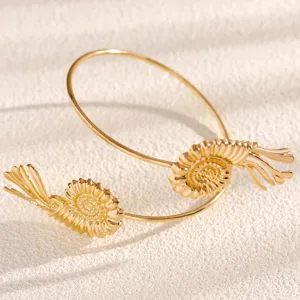 Gold seashell open arm cuff bracelet for women, perfect beach vacation jewelry detail.
