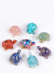 Detail shot showing multiple colorful crystal chip resin turtle ornaments with vibrant stone.