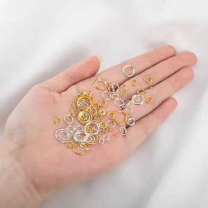 Detailed close-up shot of mixed gold and silver open jump rings for DIY jewelry parts.