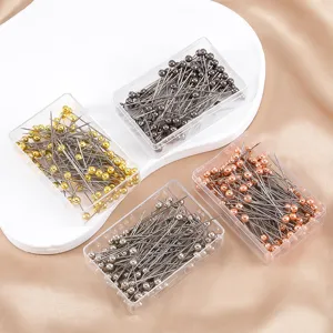 Detailed view of colorful ball head straight pins in transparent boxes for DIY sewing and jewelry.