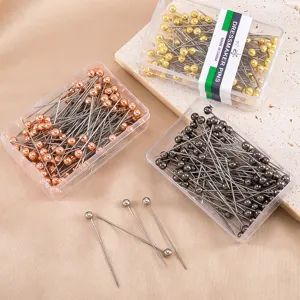 Stainless steel dressmaker pearl head pins in clear storage boxes, DIY sewing craft accessories.