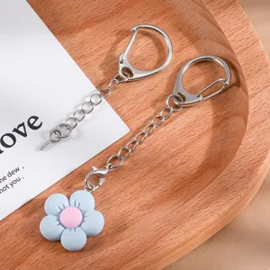 Metal D-buckle keychain with cute flower pendant, detailed view of DIY jewelry crafts.