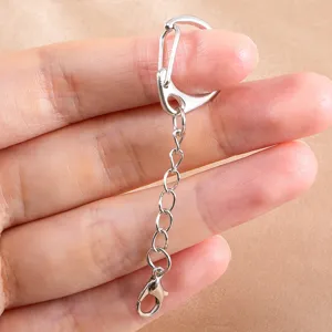 Close-up detail of silver metal D-buckle keychain chain, DIY jewelry making accessory hardware.