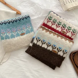 Detailed view of cozy Fair Isle knitted winter scarf, thick warm woolen shawl for women.