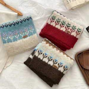 Detailed view of Fair Isle knit winter scarf with cozy floral patterns and woolen fabric.